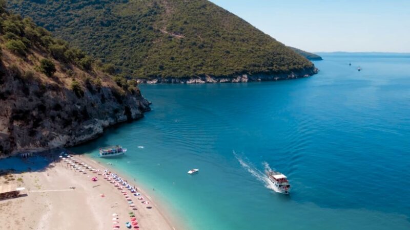 Aerial view of an Albanian secluded beach nestled within a rocky cove