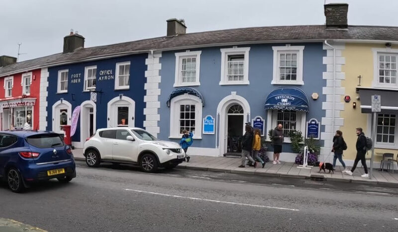Vibrant pastel-colored buildings line the street in Aberaeron