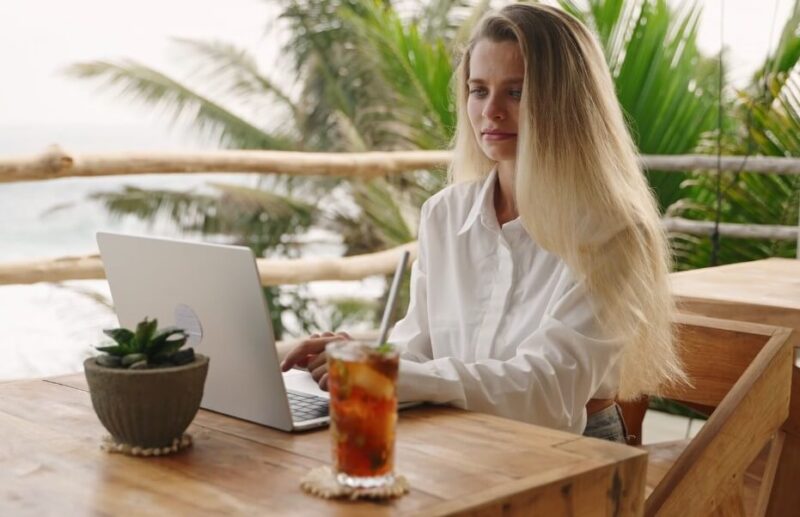 Woman working on a laptop during a vacation